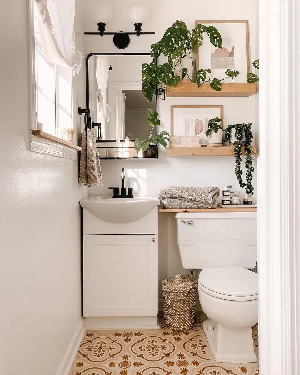 Bright white small bathroom with a large black-framed mirror, wooden shelves, plants, a vanity, and a toilet.