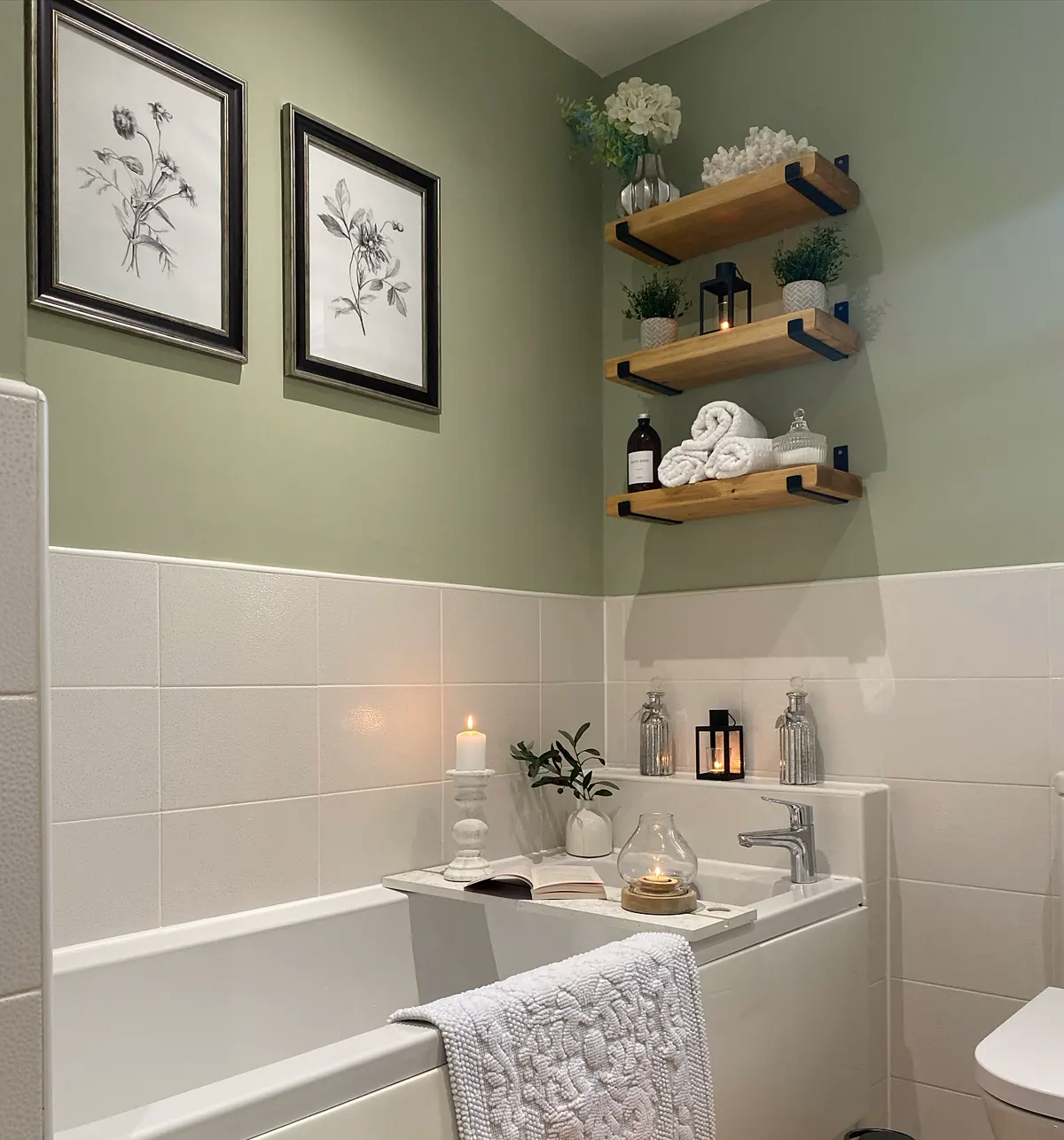Colorful bathroom with dark green vanity, peach walls, tropical floral wallpaper, pink vessel sink and green ottoman