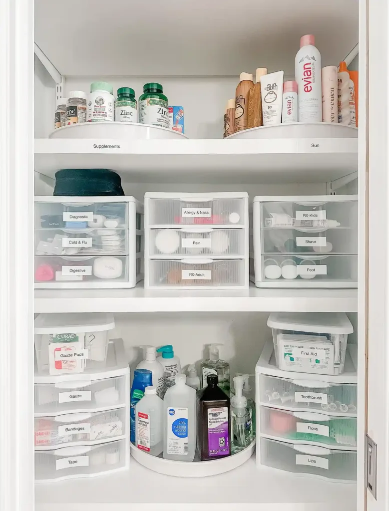 Organized bathroom shelves with stacked clear drawers, labeled storage compartments, and rotating organizers for toiletries.