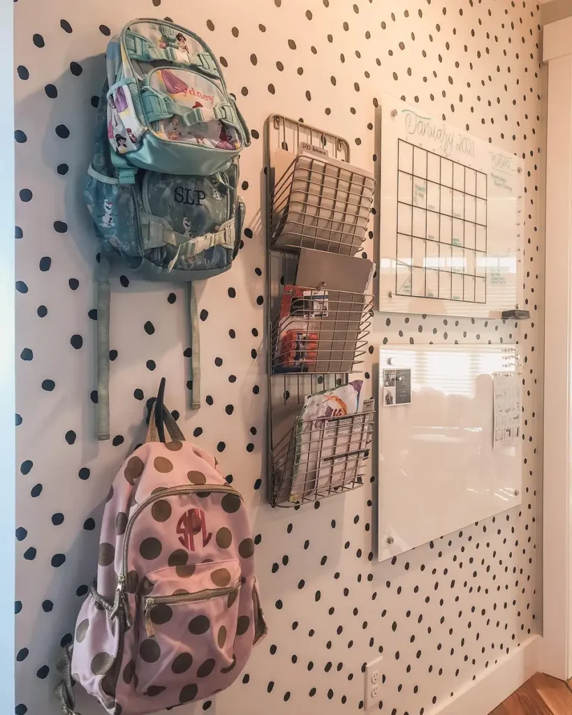 Back-to-school command wall with backpack hooks, wire paper baskets, calendar, and dry erase board.