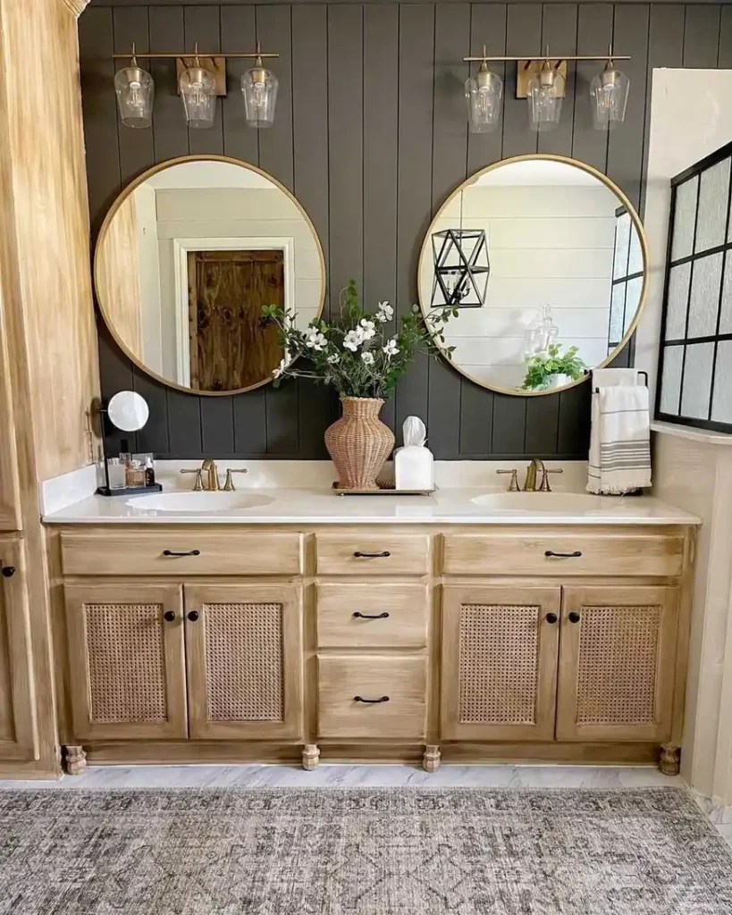 Double bathroom vanity with a woven vase of white flowers centered between two sinks and a tissue box beside it.