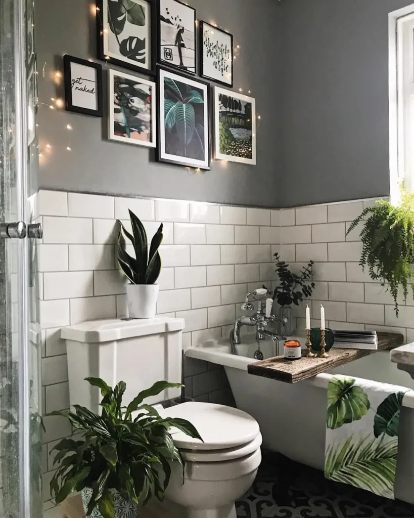 Compact bathroom gallery wall with botanical and animal prints in black and white frames above white subway tile.
