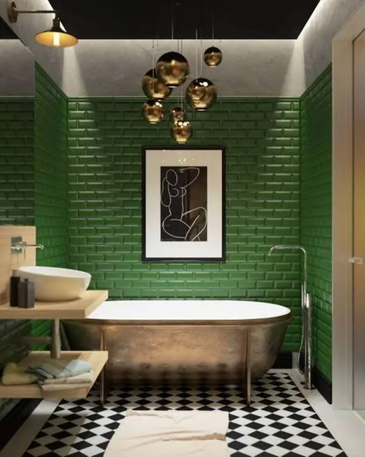 Deep green subway tile bathroom with aged metal freestanding tub, black-and-white checker floor and gold pendant lights