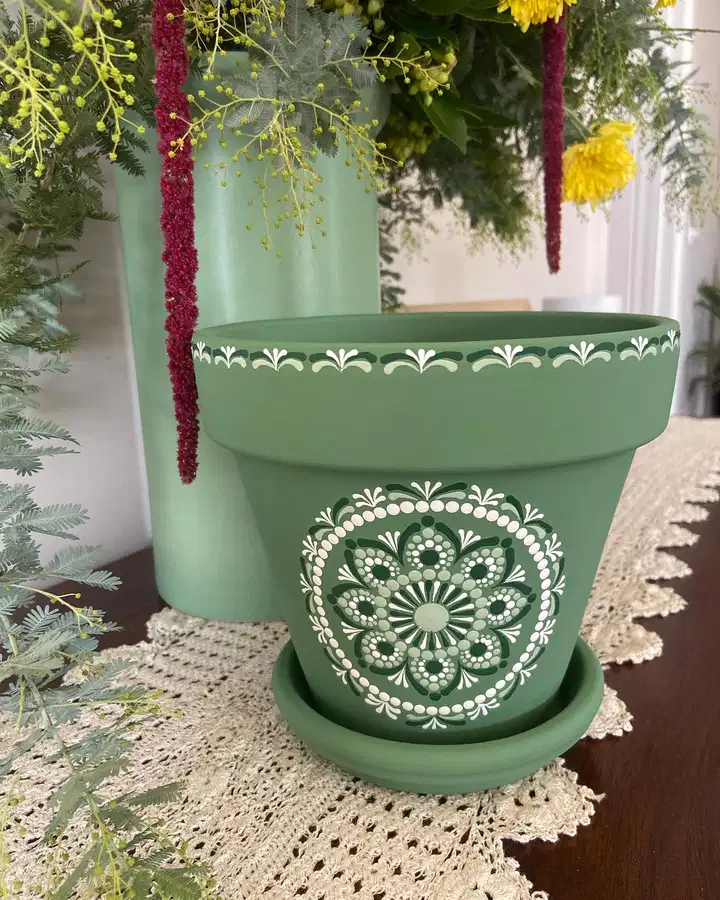 Muted green flower pot featuring a detailed white and dark green circular mandala design