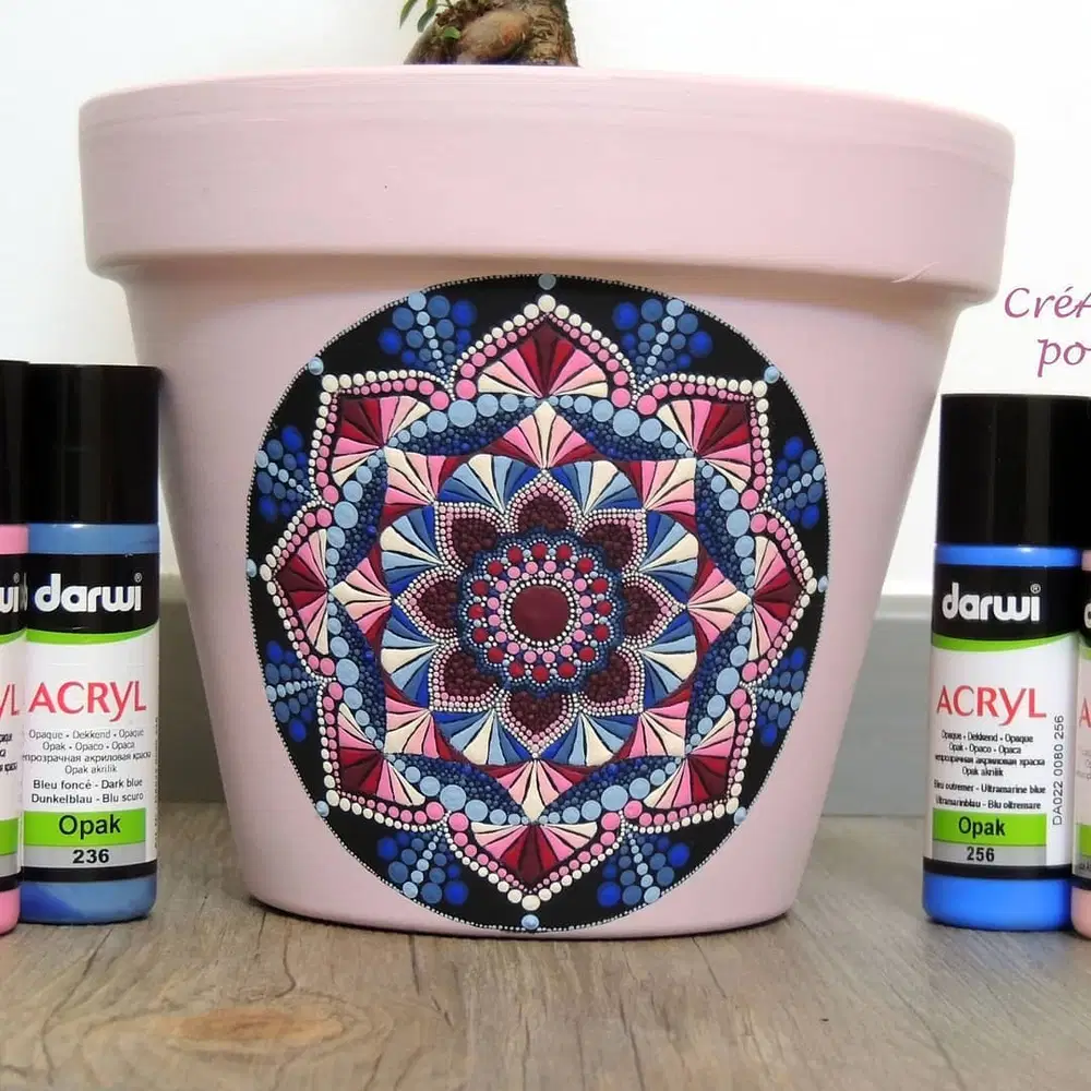 Pale pink flower pot featuring an intricate pink, blue, burgundy, and white dot mandala