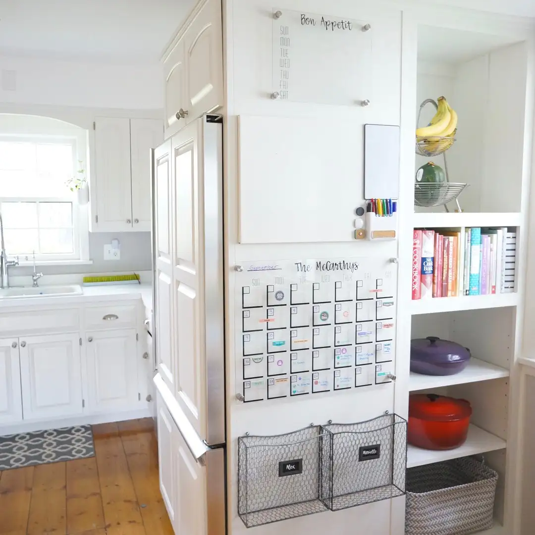 Small entryway command center with wall calendar, memo board, and wire baskets for papers