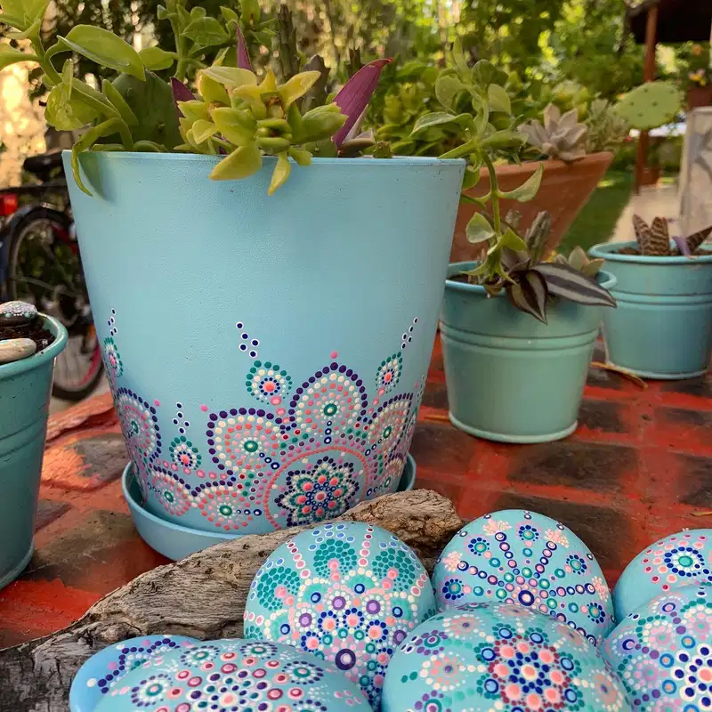Aqua flower pot decorated with coral, purple, teal, and white dotted lace patterns along the base