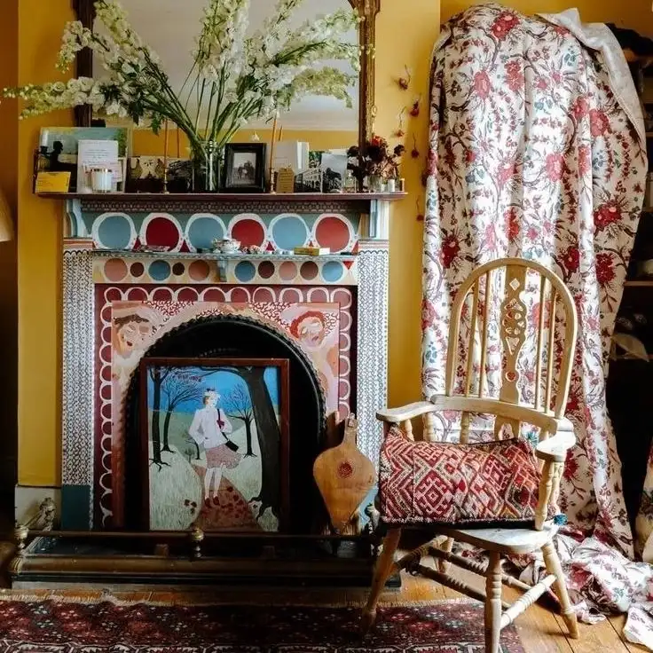 Eclectic hallway with mustard walls, patterned fireplace surround, floral textiles, carved chair, and colorful rug