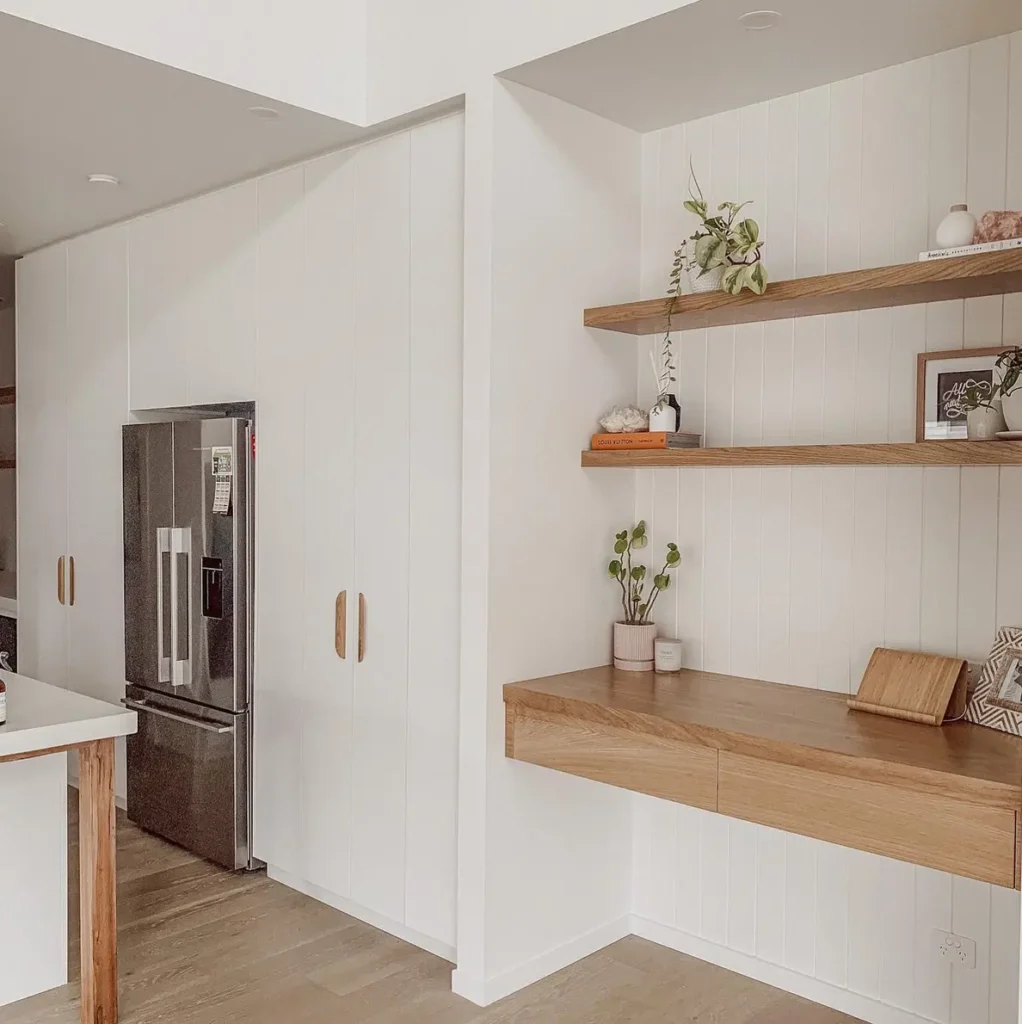 Floating wooden kitchen drop zone with slim drawers, open shelves, and space for keys and mail.