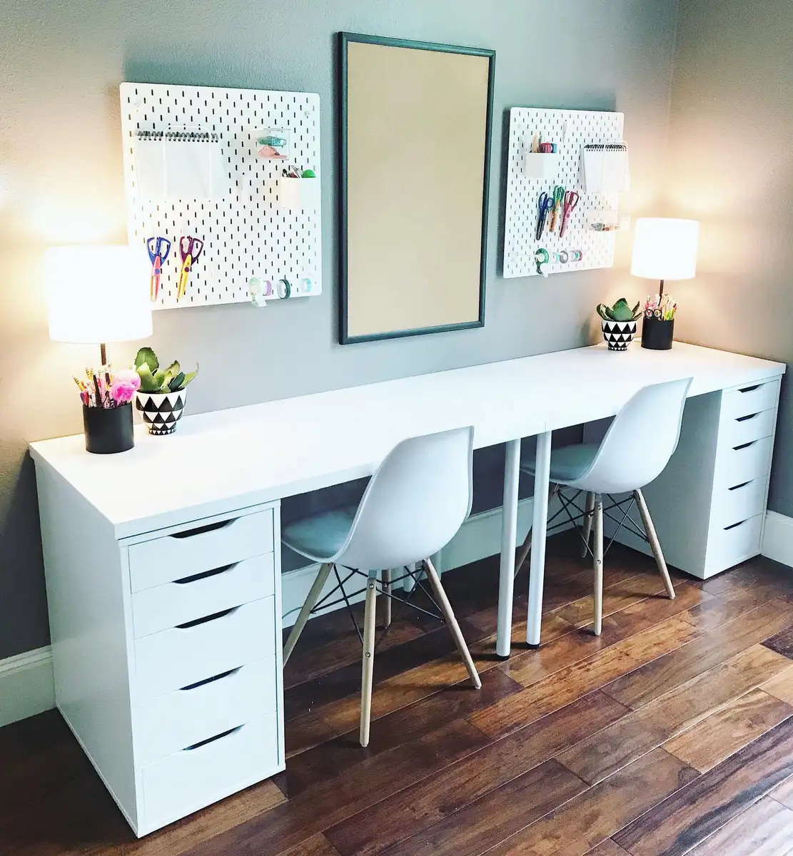 Shared two-seat homework station with pegboards, drawer units, and organized school supplies
