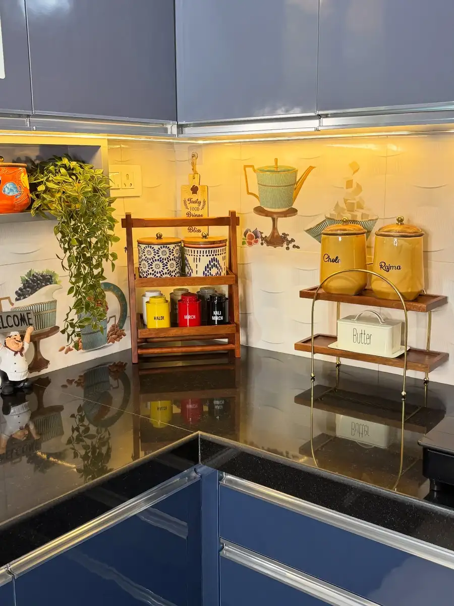 Kitchen counter with wooden spice racks, yellow storage jars, trailing plant and organized pantry containers