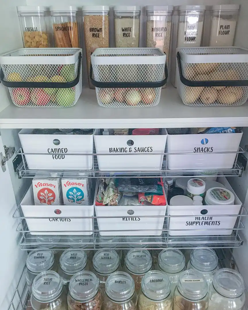 Deep pantry shelves organized with tall clear containers at the back and removable baskets at the front