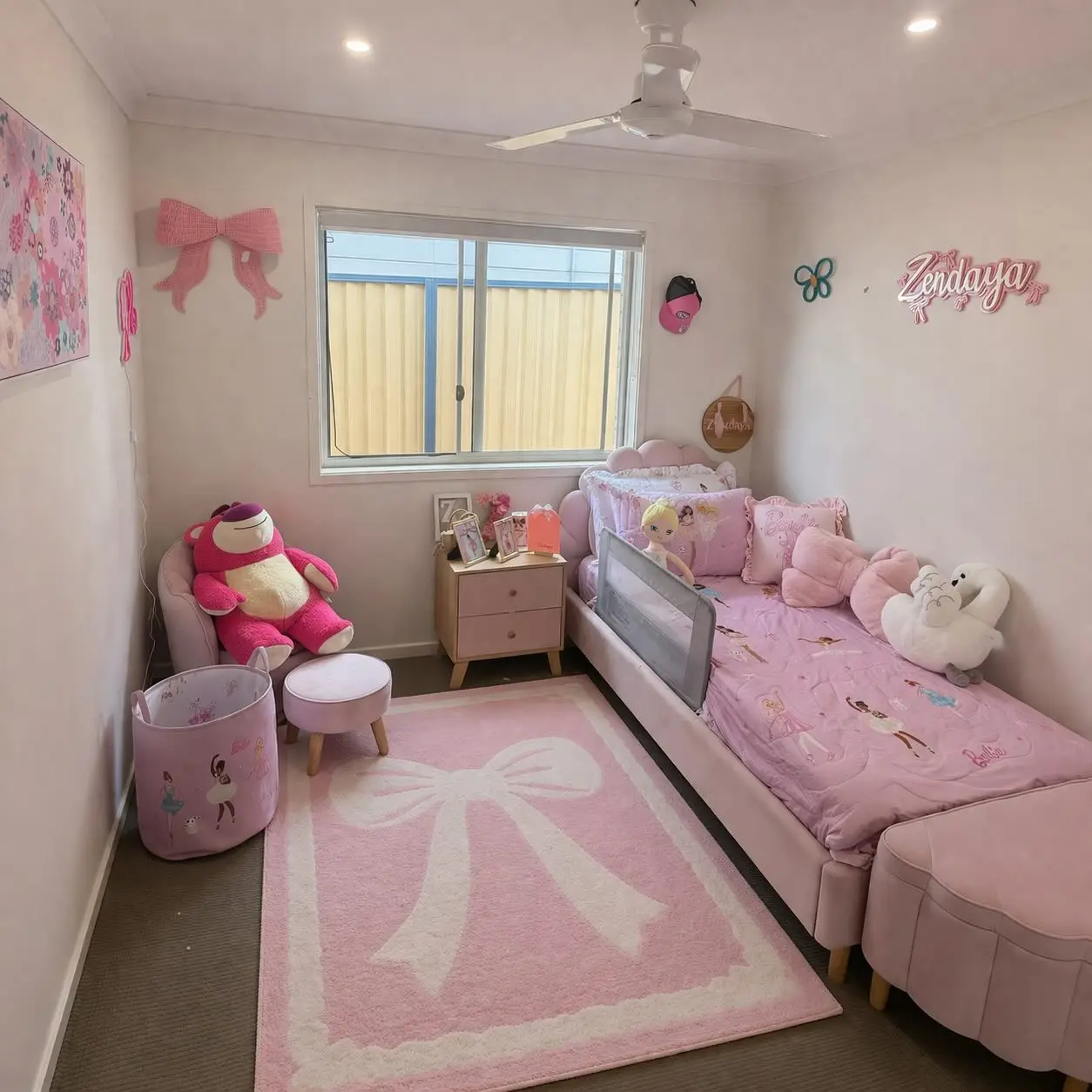 Small pink girls bedroom with bed along the wall, bow-shaped rug, chair, and open floor space