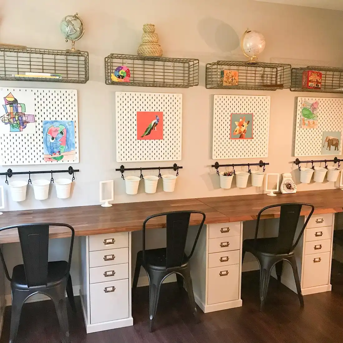 Multi-seat homework station with individual pegboards, hanging supply cups, drawers, and wall baskets