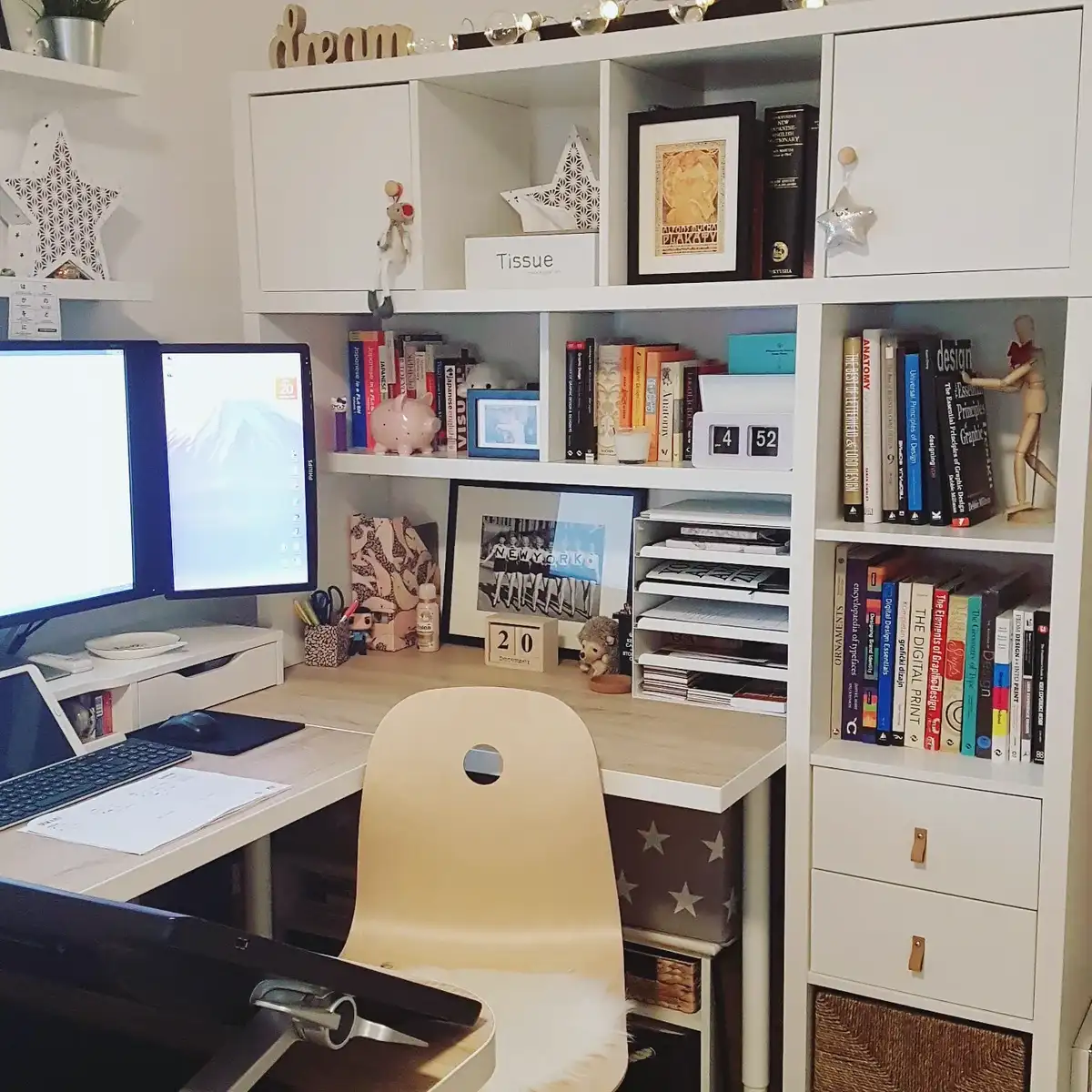 Homework desk built into shelving with books, cabinets, baskets, and vertical paper organizers