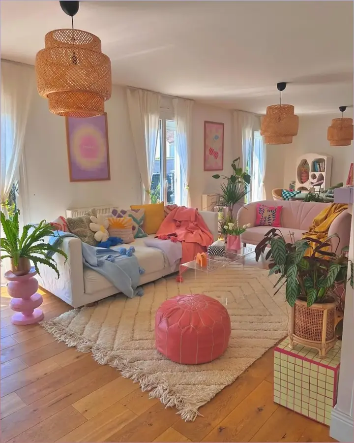 Soft colorful living room with cream sofa, pastel cushions, pink pouf, blue and yellow accents, and light artwork