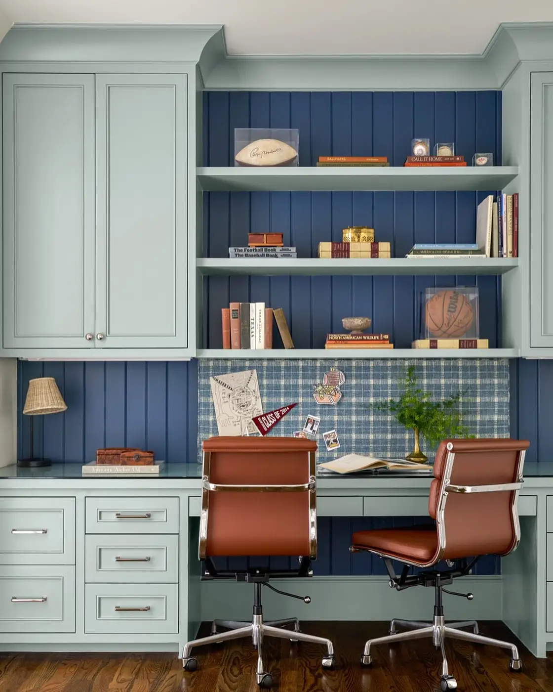 Built-in homework desk with tall cabinets, open shelving, drawers, and a large pinboard