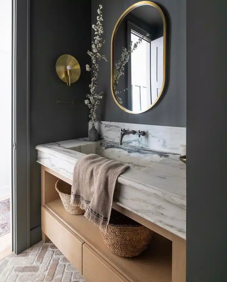07 Bathroom vanity with drawers, open lower shelf, woven baskets, and rolled towels