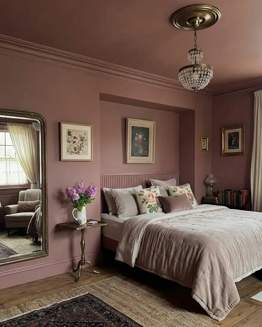 Dusty pink bedroom with matching walls and ceiling, cream bedding and floral accents