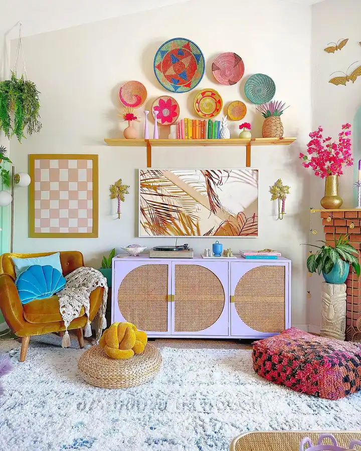 Colorful living room with woven wall baskets, mustard chair, lavender cabinet, turquoise cushion, plants, and patterned pouf
