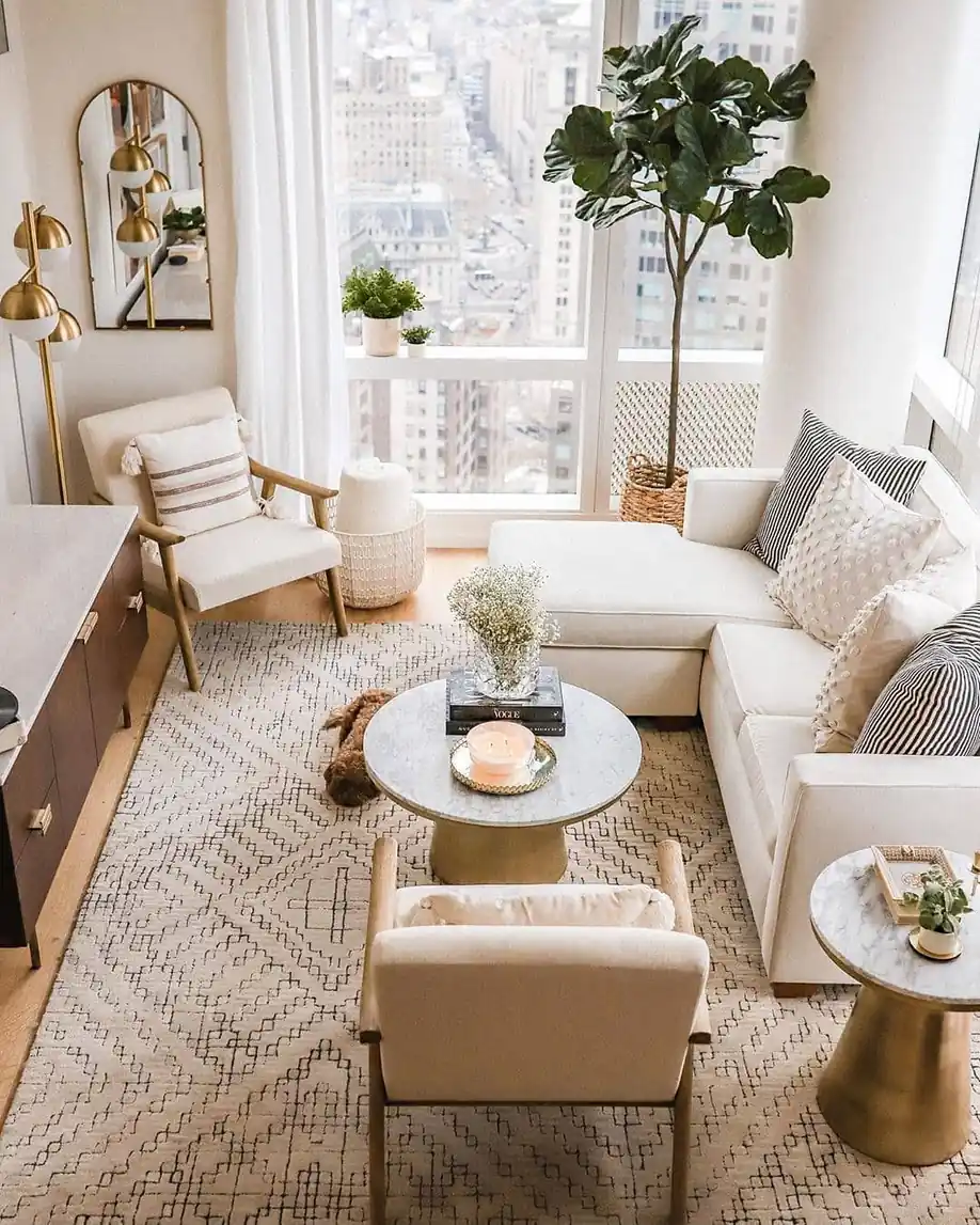 Narrow living room with a wall-mounted TV, slim media console, sectional sofa, and open floor space