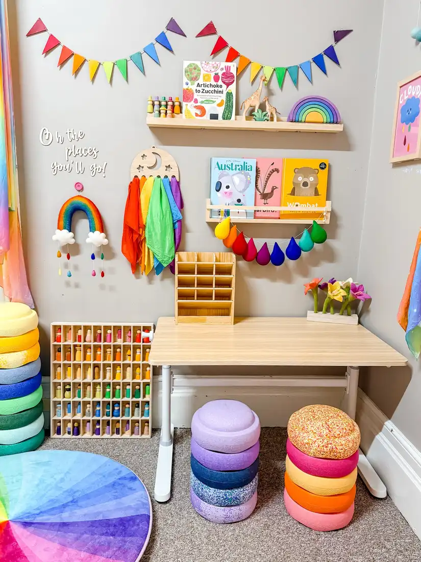Colorful kids homework station with wood desk, wall book ledge, art supplies, and storage cubbies