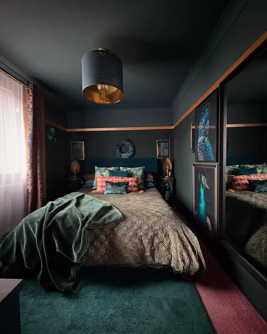 Dark bedroom with thin copper wall trim, coral pillow, green throw and teal rug