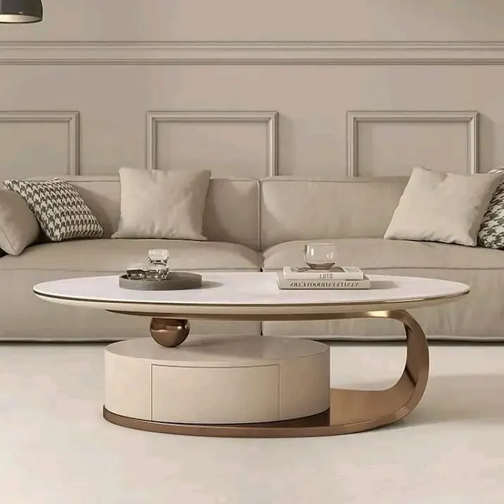 Sculptural coffee table styled minimally with a small tray, stacked books, and low decorative pieces