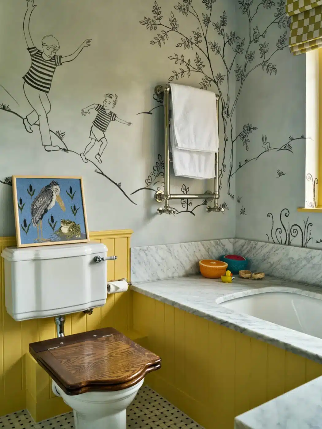Bathroom with illustrated storybook wall mural, mustard paneling, marble tub surround, and bird artwork