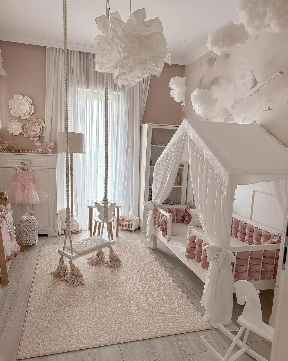 House-shaped girls bed with white curtains, pink cushions, indoor swing, clouds, and bird wall decor