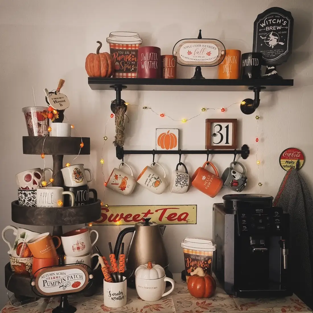 Fall-themed coffee station with seasonal mugs, pumpkins, string lights, black shelves, mug rail, and coffee machine