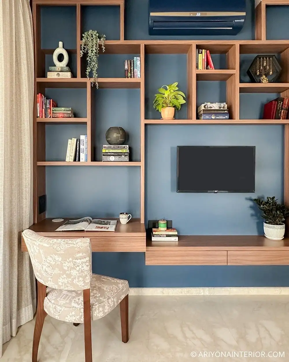 Homework desk integrated into a wall of built-in shelves, cabinets, books, and storage