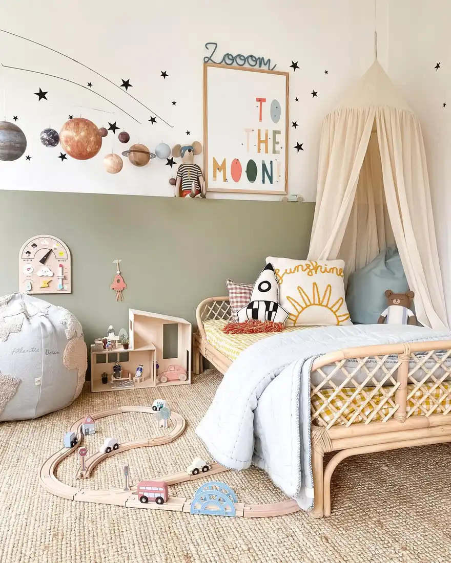 Boho space-themed bedroom with rattan bed, pale canopy, natural wood, and planet wall decor