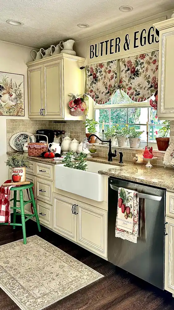 Kitchen window with floral valance, grouped pale pots, terracotta pots, and tall candles