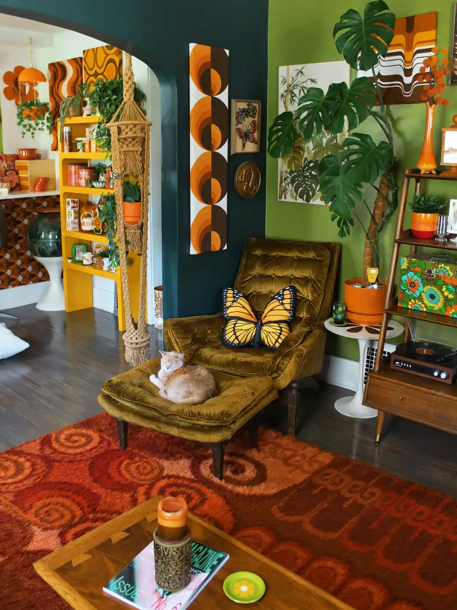 Retro living room with olive velvet chair, burnt orange accents, shag rug, geometric art, and large plants