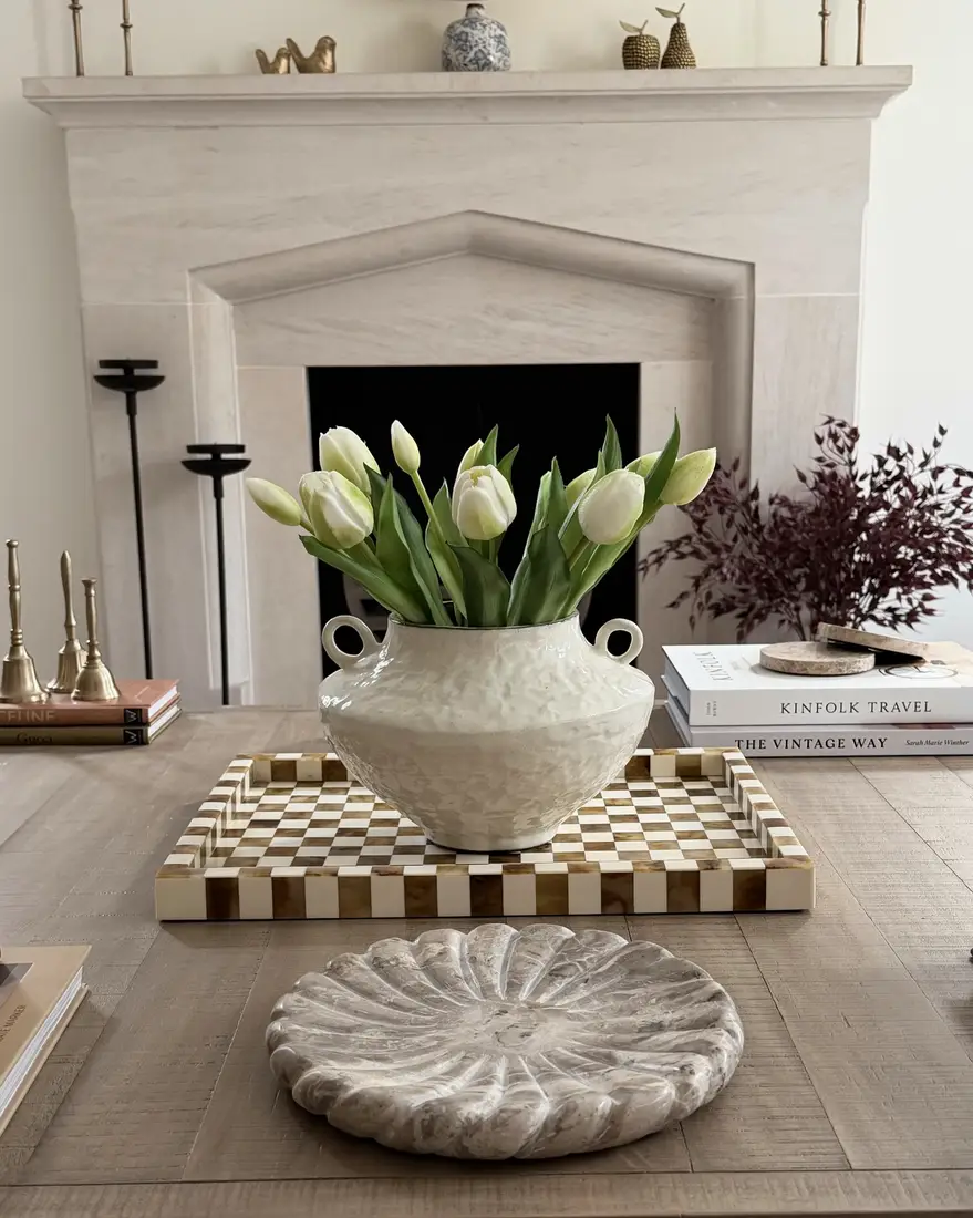 Checkerboard coffee table tray with large cream vase filled with white tulips