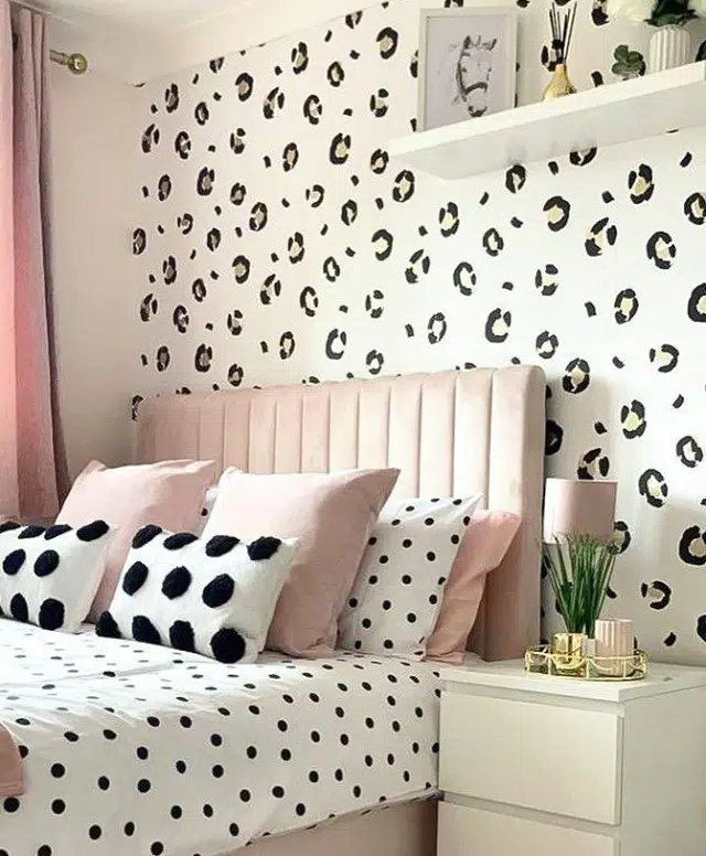 Bedroom with large leopard wall spots, black polka dot bedding and blush pink accents
