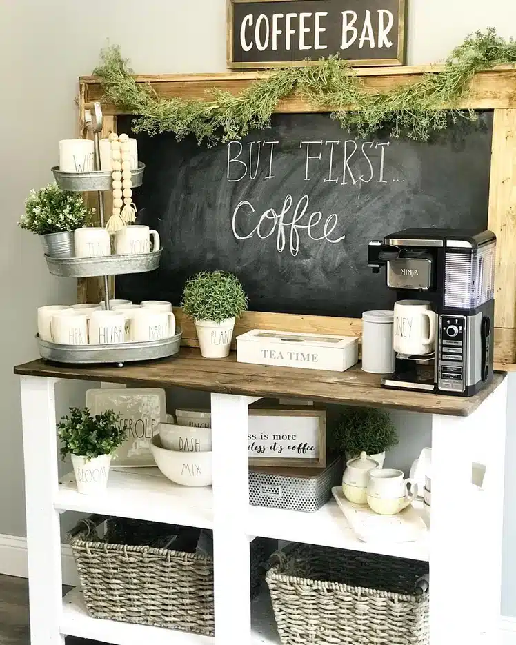 Farmhouse coffee bar with oversized framed chalkboard, galvanized tiered tray, mugs, greenery, coffee machine, and wood accents