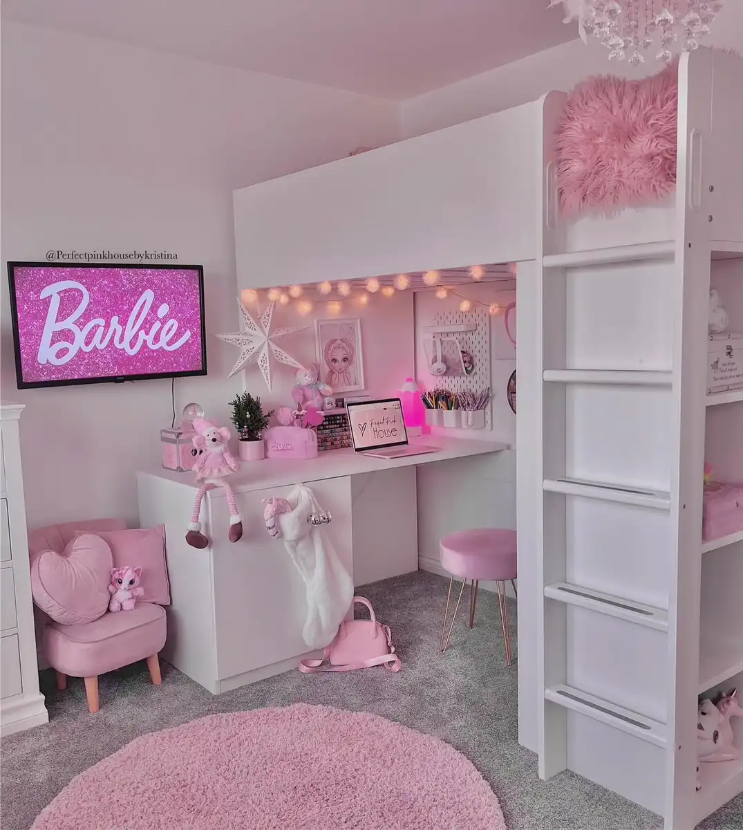 White loft bed with study desk underneath, pink chair, craft supplies, storage, and pink rug