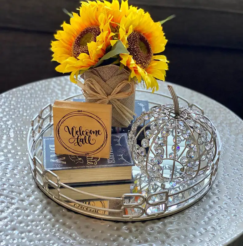 Fall coffee table tray with bright yellow sunflowers, burlap wrapped vase, sparkling pumpkin, books, and rustic accents