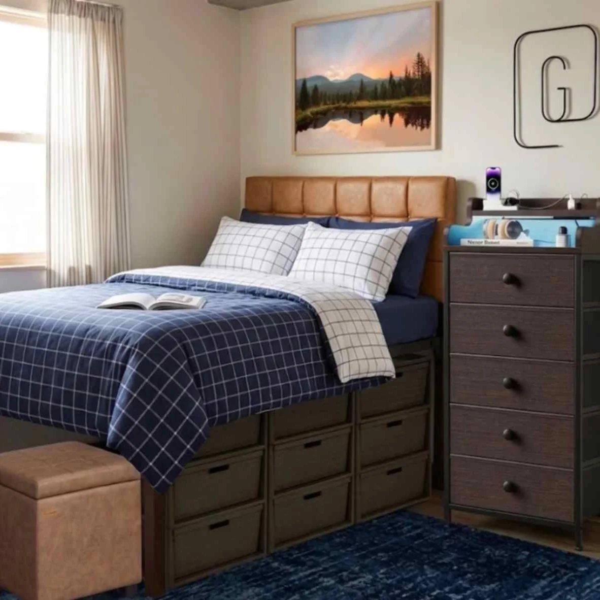 Raised dorm bed with built-in drawers, navy plaid bedding, and compact storage underneath
