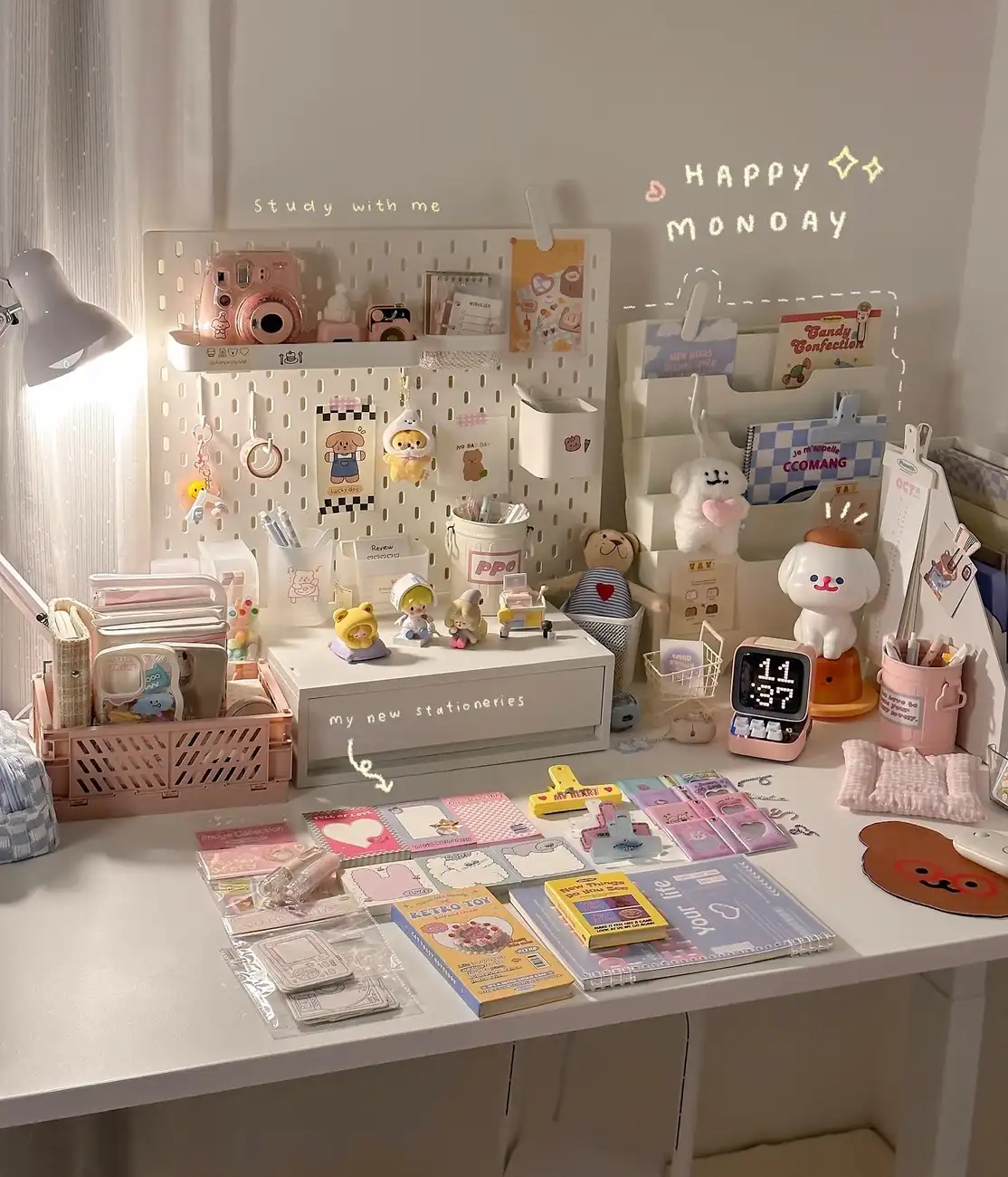 Colorful dorm desk with pastel stationery, small collectibles, wall storage, and notebooks