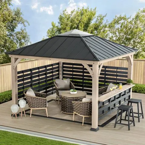 Covered gazebo with dark roof, woven lounge chairs, and long outdoor bar counter with stools