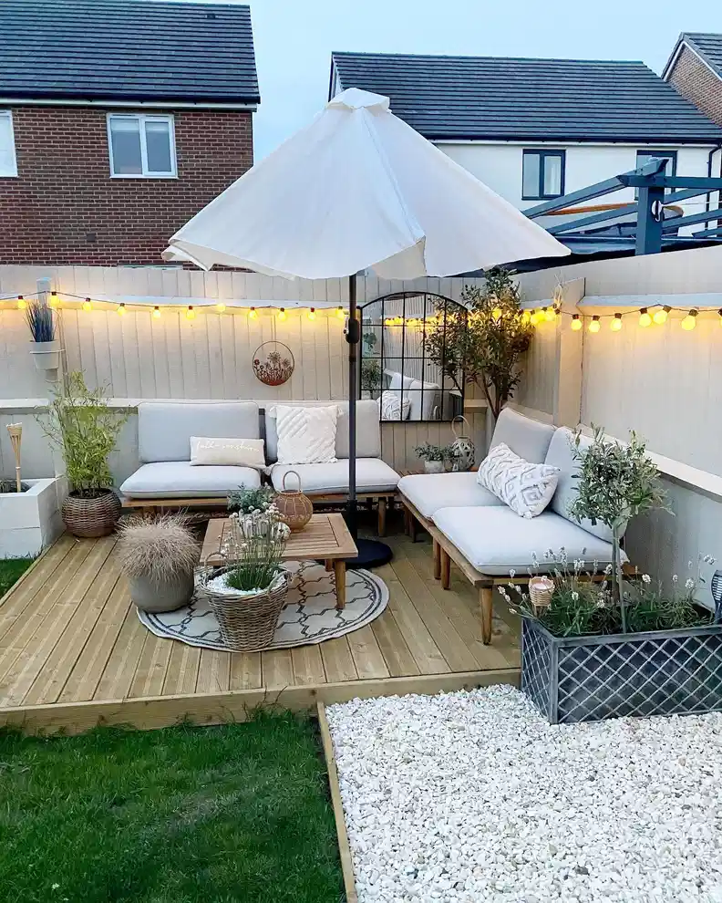 Outdoor string lights outlining a backyard lounge beneath a pale umbrella-style canopy
