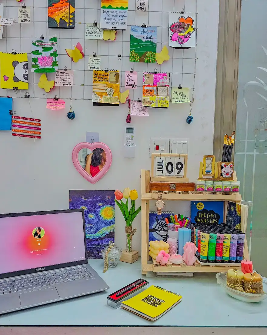 Colorful dorm desk with wire memo grid, notes, photos, art, and bright accessories