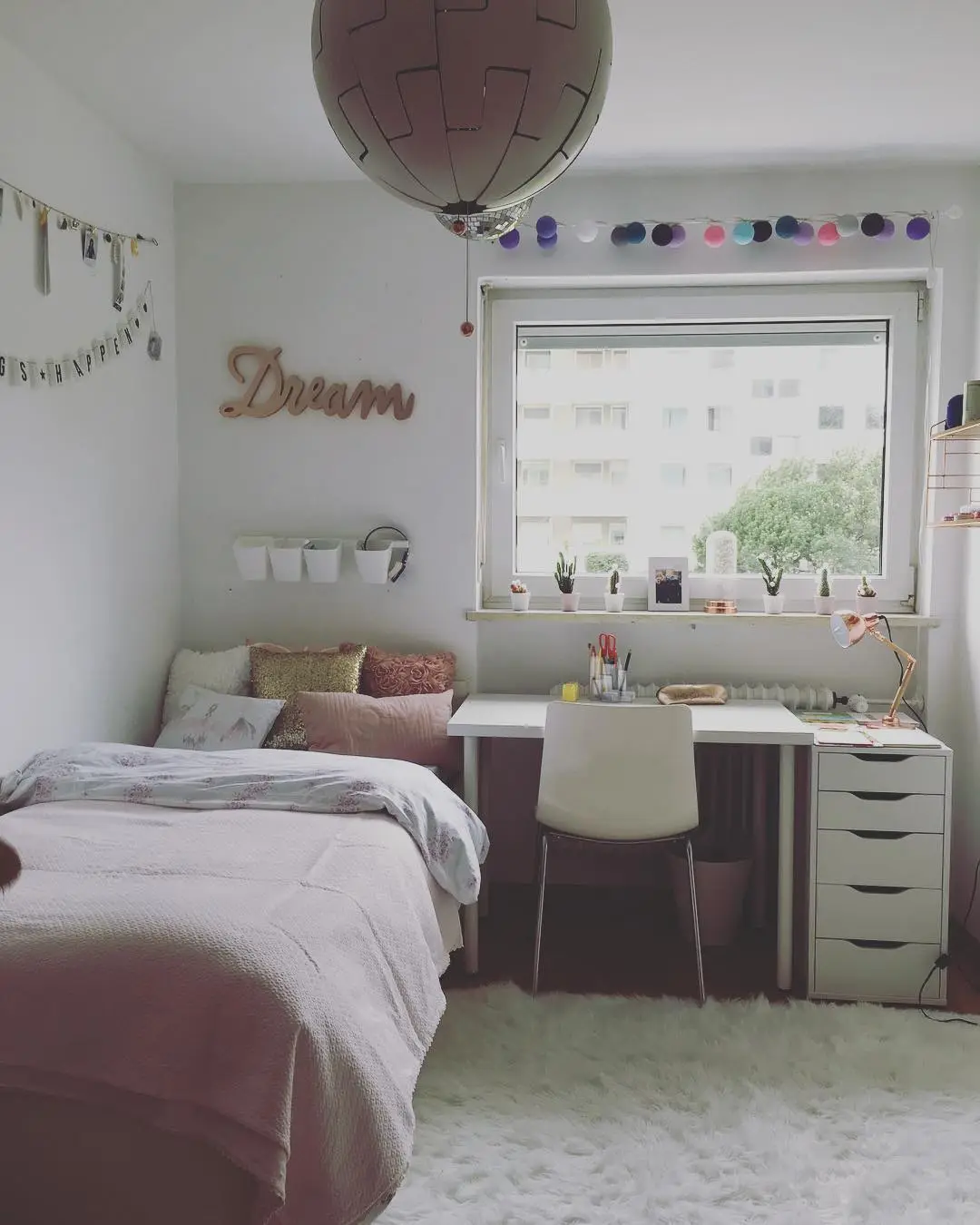 Narrow kids bedroom with single bed along the wall and compact desk beneath the window
