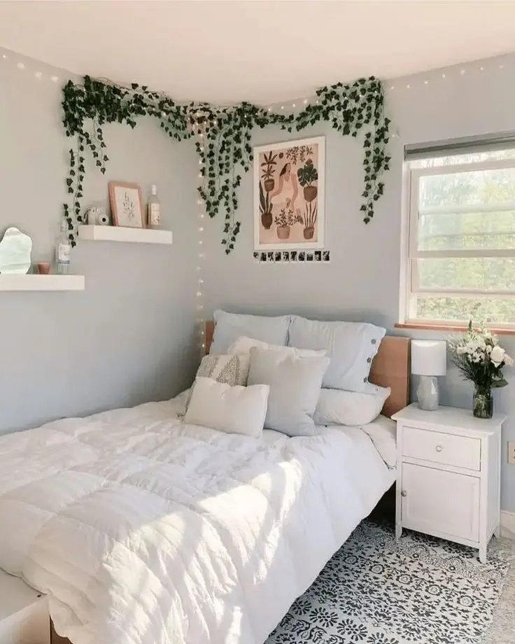 Small bedroom decorated with trailing vines and string lights around the ceiling