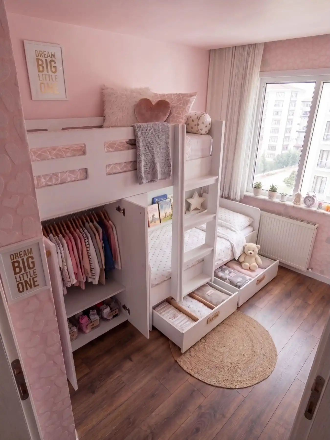 Pink shared kids bedroom with bunk beds, built-in drawers, and open clothing storage