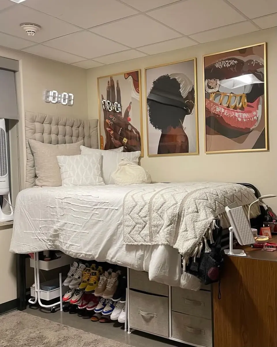Light dorm room with white bedding and shoes, drawers, bins, and storage organized under the raised bed