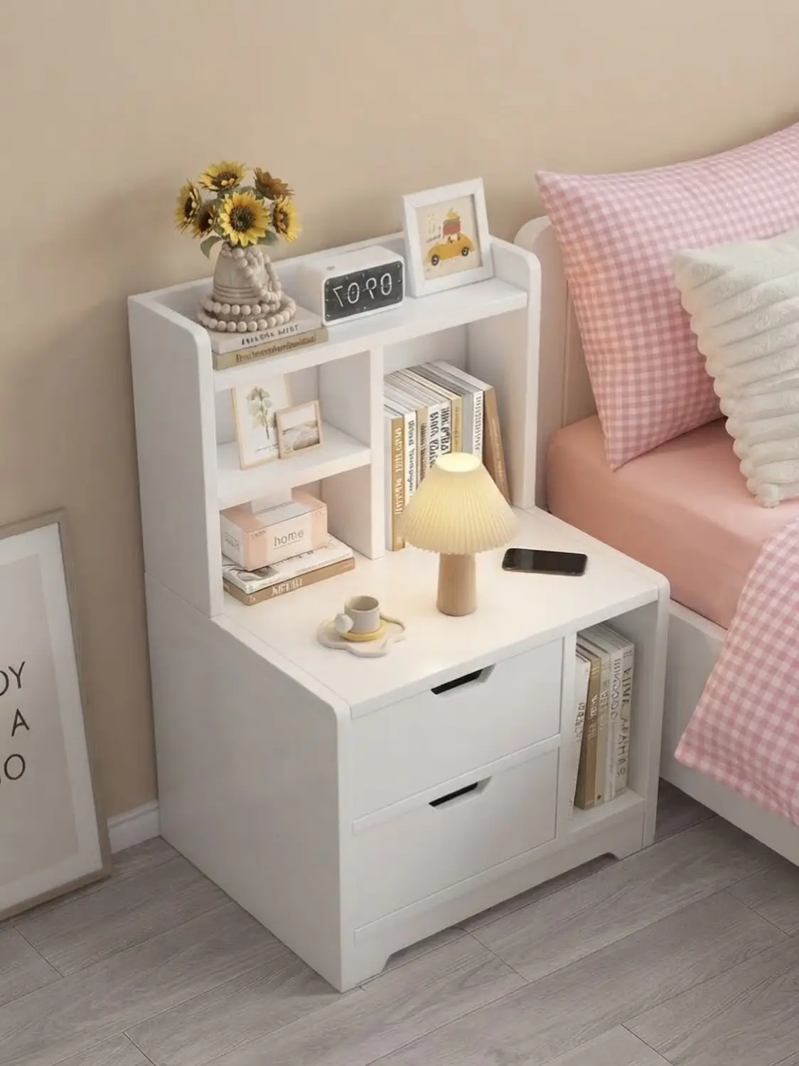 Compact bedside storage unit with drawers, open shelves, book slot and table lamp